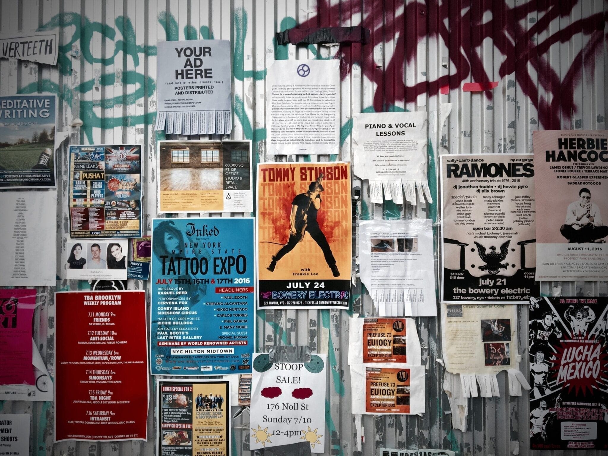 wall with posters and flyers hanging